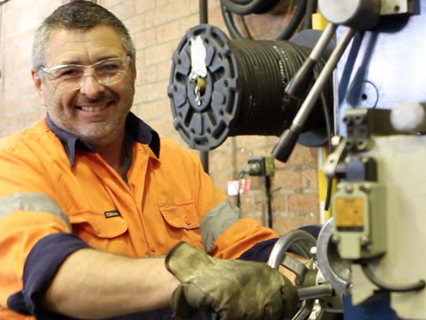 Melvelle service technician working on rail equipment